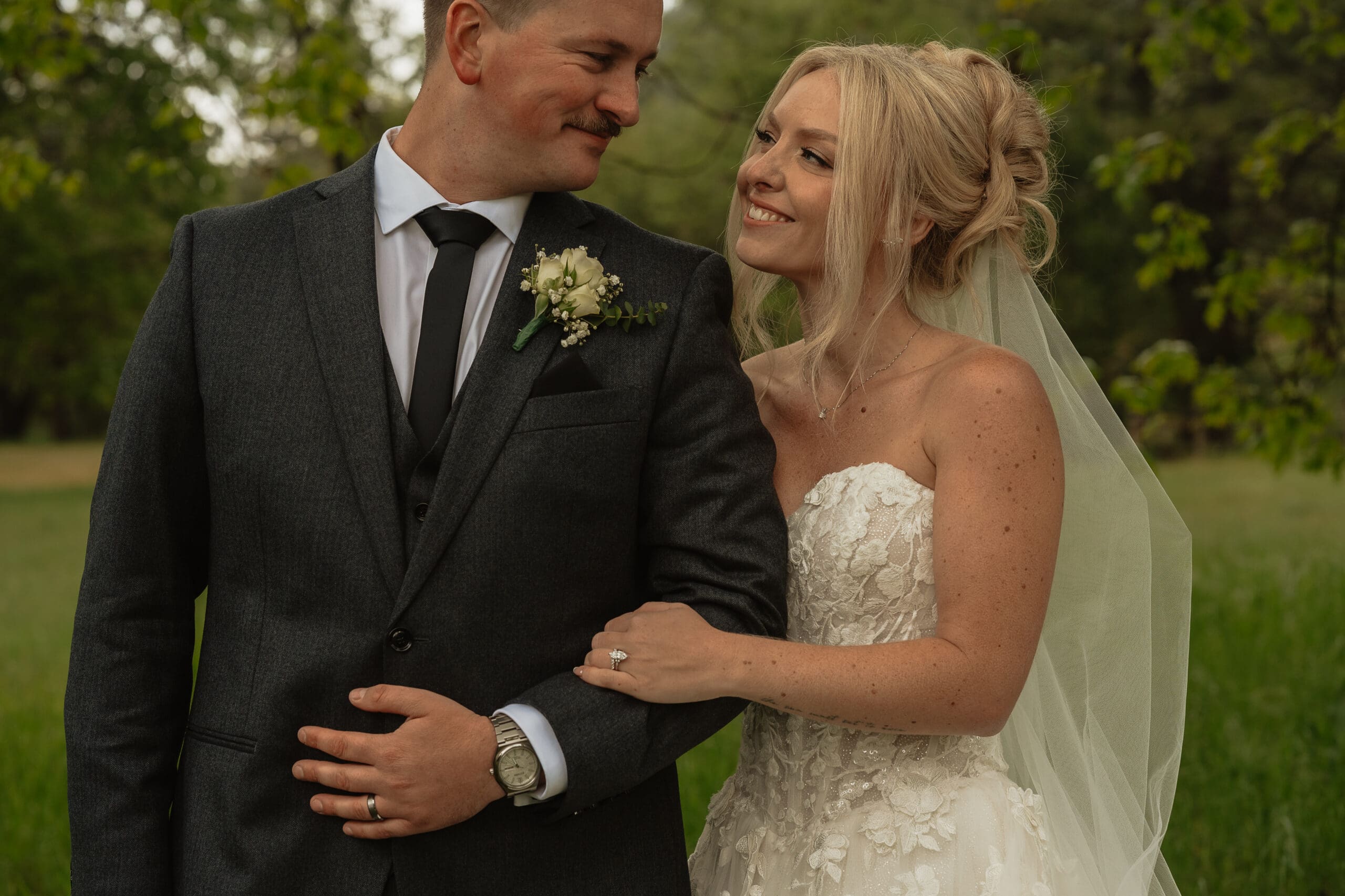 Bride embracing groom during romantic rainy wedding portraits at Firefall Ranch near Yosemite National Park